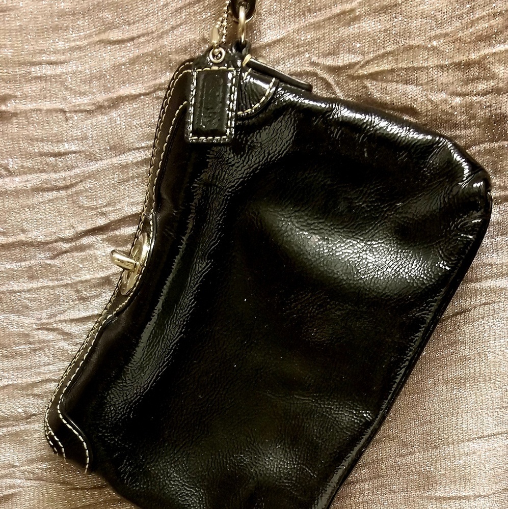 Coach Patten leather black wrist laying gently use